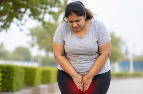Woman experiencing inner thigh chafing caused by skin friction and sweat.